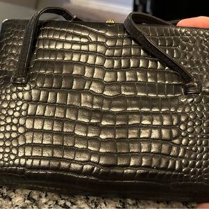COBLENTZ Worn Crocodile 1960’s Handbag. It is black in color.